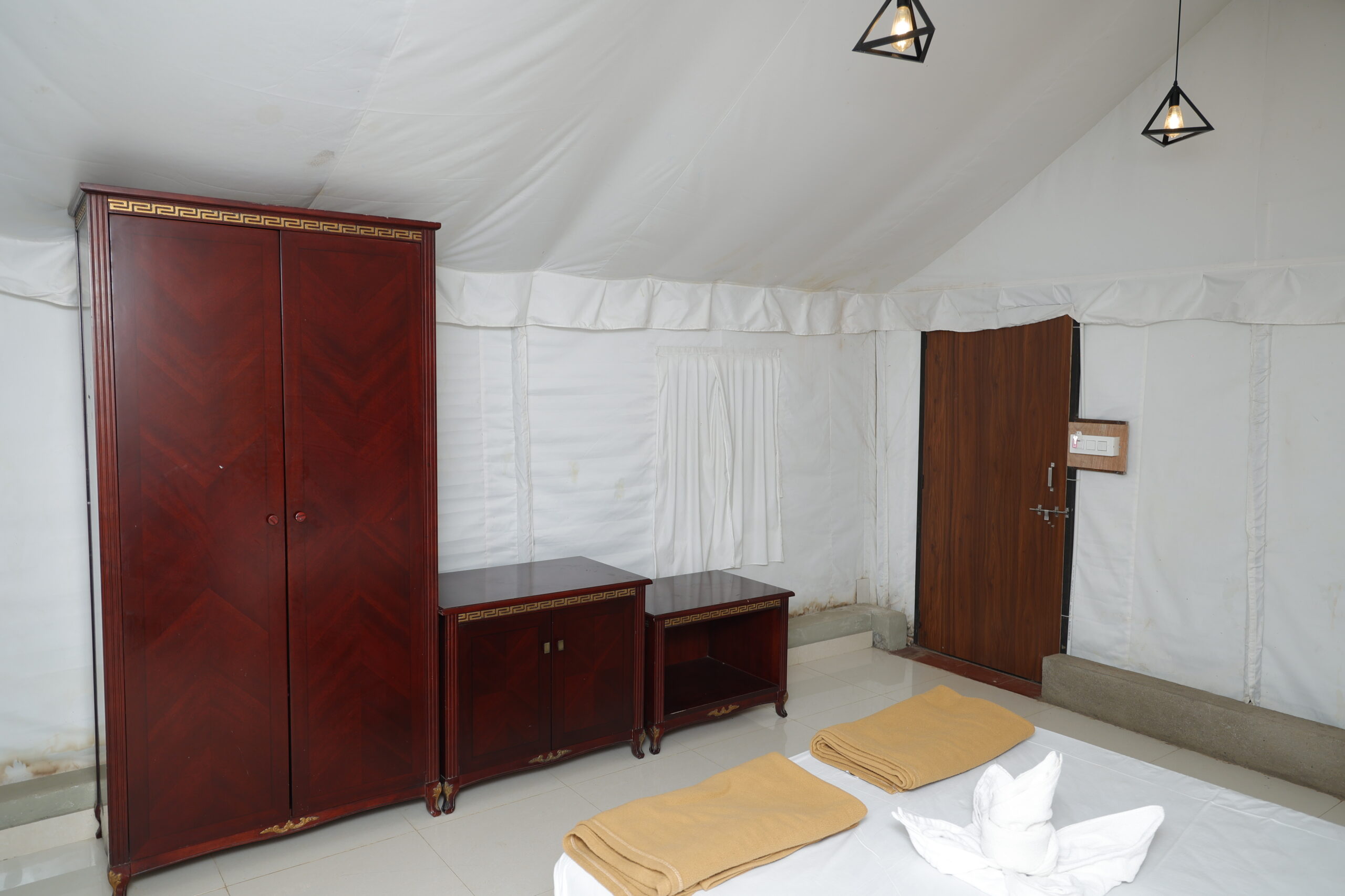 Premium bedding setup inside Maharaja Tent in Dandeli Karnataka