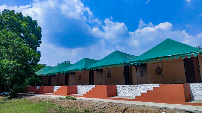 Comfortable luxury tent interior with bedding at Dandeli jungle resort
