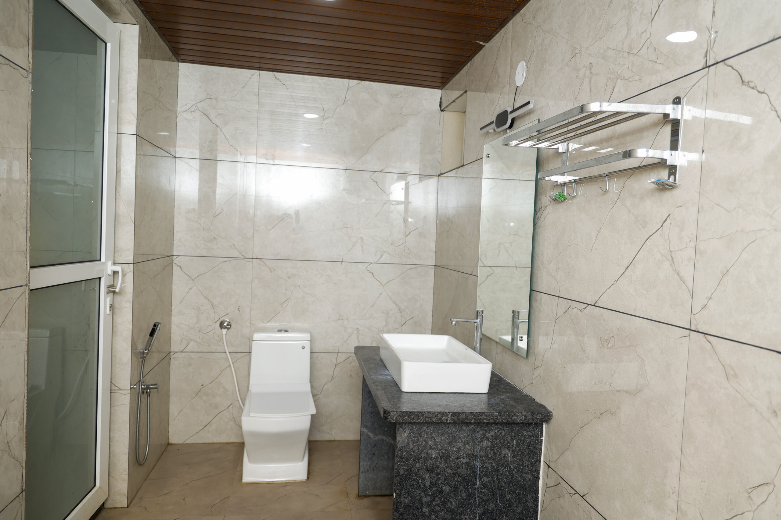 Clean attached bathroom inside AC Deluxe Room at Ashoka Jungle River Resort